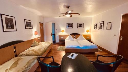 a living room with two beds and a couch at Hotel-Landgasthof Grüner Baum - Dittigheim in Tauberbischofsheim