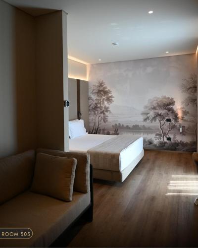 a bedroom with a bed and a painting on the wall at Elmares Hotel in Himare
