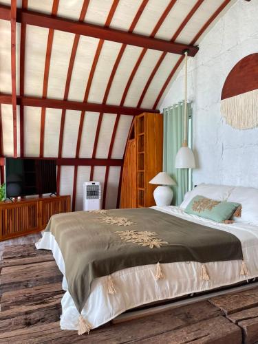 a bedroom with a large bed in a room at Eywa Retreat in Uluwatu