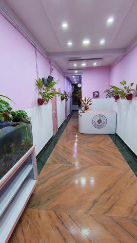 a room with potted plants and a wooden floor at Mysore Nivas - ADH in Mysore