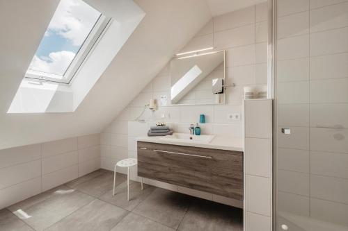 ein Badezimmer mit Waschbecken und Dachfenster in der Unterkunft Gästehaus Lodermeier in Bad Abbach