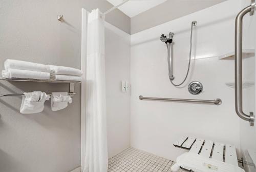 a white bathroom with a shower and a toilet at Quality Suites Pineville - Charlotte in Charlotte