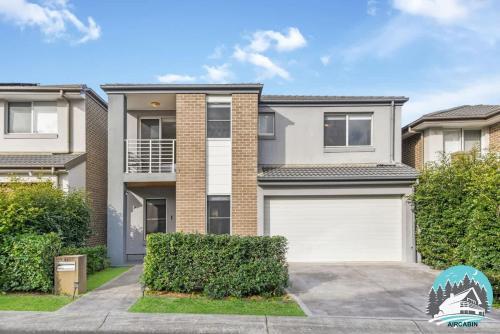 an image of a house with a garage at Spacious 4BR Yard Retreat in Kellyville