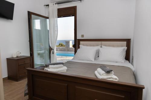 a bedroom with a bed with towels on it at Vakontas Luxury Stay in Gerolimenas