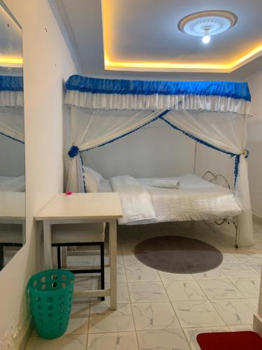 a bedroom with a bunk bed and a table at Nairobi Transit Lounge in Nairobi