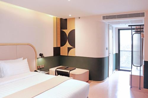 a hotel room with a bed and a window at The Quarter Ratchathewi by UHG in Bangkok