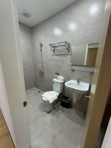a bathroom with a toilet and a sink at 滸衖海旅 in Anping