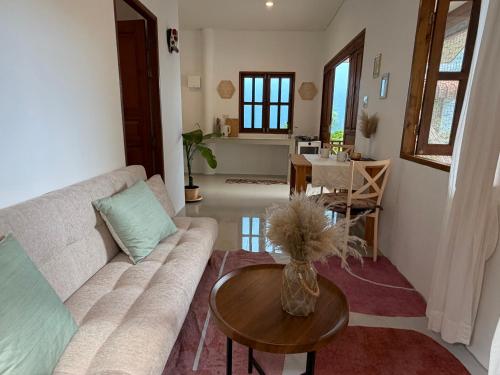 a living room with a couch and a table at Thong Sala Japandi Villa in Thong Sala