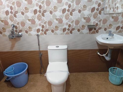 a bathroom with a toilet and a sink at Govindha bhavanam 150 meters from Guruvayur temple in Guruvāyūr