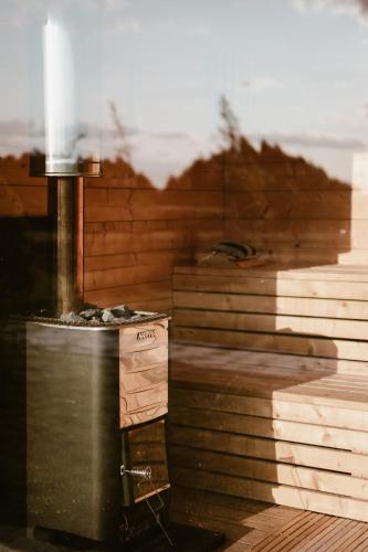 a kitchen with a stove and a stack of books at Jemiołucha Glamping in Bodzentyn