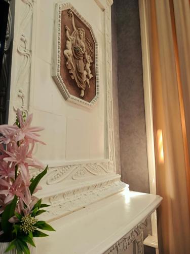 a wall with a picture of a woman on a wall at Baku City Inn Boutique Nizami Hotel in Baku