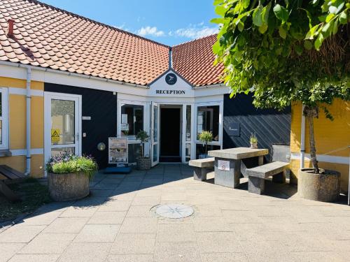 a building with two benches in front of it at Danhostel Skagen in Skagen