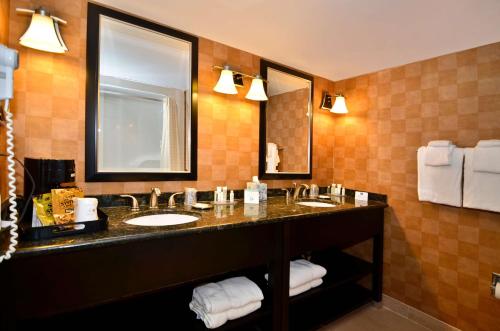 a bathroom with two sinks and a large mirror at Best Western Plus BWI Airport Hotel - Arundel Mills in Elkridge