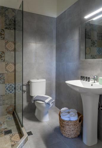 a bathroom with a toilet and a sink and a shower at Flower in Skiathos
