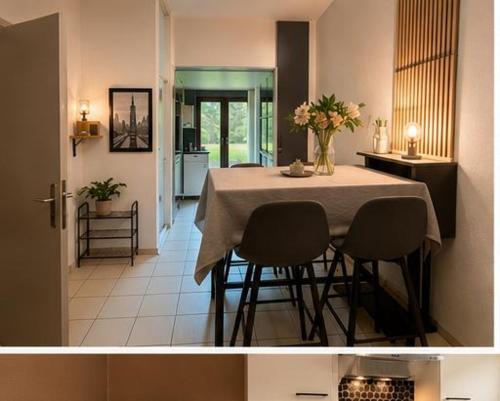 a dining room table with two chairs and a table with flowers on it at Citadelle Liège Centre in Liège