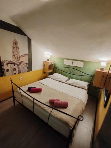 a bedroom with a bed with two red pillows on it at Inspiration room - Toć in Split