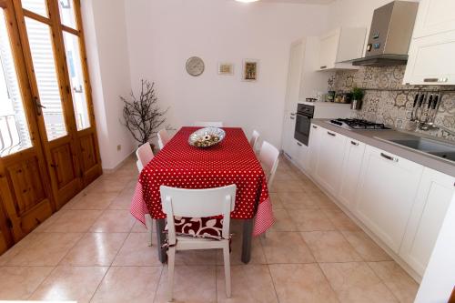 カンネートにあるCasa Francesca Cannetoのキッチン(赤と白のテーブル、椅子付)