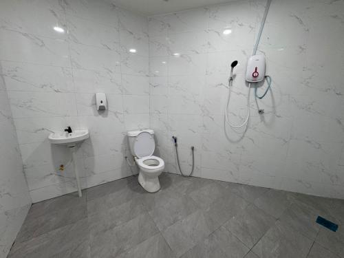 a bathroom with a toilet and a sink at MN Ferringhi Inn in Batu Ferringhi