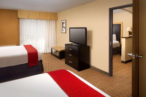 a hotel room with a television and a bed at Best Western Alamo Suites Downtown in San Antonio