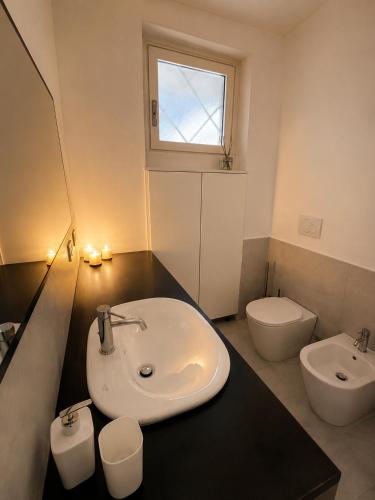 a bathroom with a sink and a toilet at Casa PG - Appartamento Vista Lago in Monte Isola