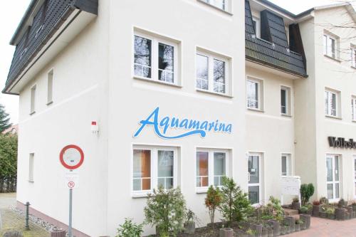 a white building with theaniaania sign on it at Bansin, Aquamarina WG 10 in Bansin