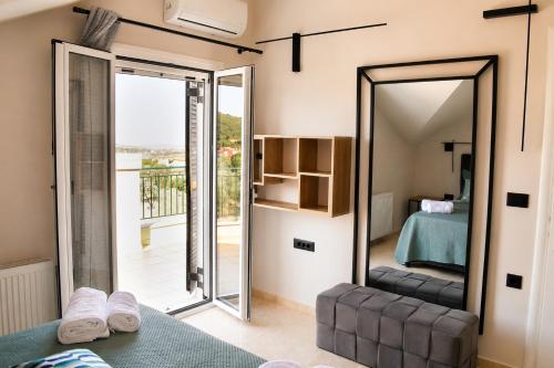 a mirror in a room with a bed and a bedroom at Luminosa Collection - Casa Celeste in Razáta