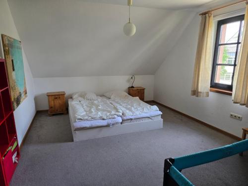 a bedroom with a bed in the corner of a room at idyllisches Mühlengebäude in Hillesheim