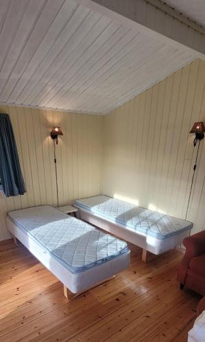 two beds in a room with two lights at Sona Camping in Hegra
