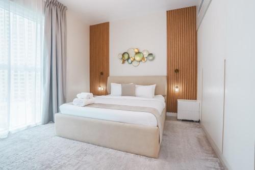 two beds in a room with white walls and windows at La Vie on JBR in Dubai