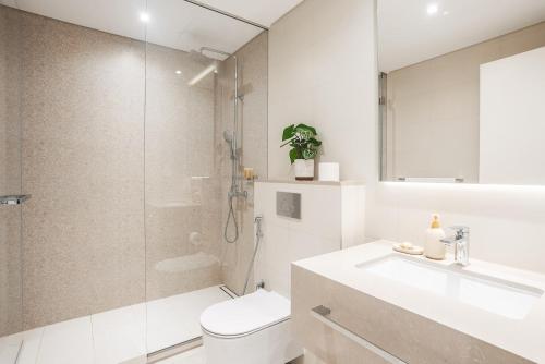 a bathroom with a toilet and a sink and a shower at La Vie on JBR in Dubai