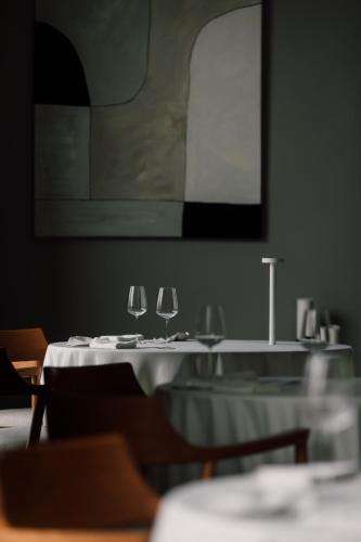 a dining room with two tables with wine glasses on them at Teruar Urla in Urla