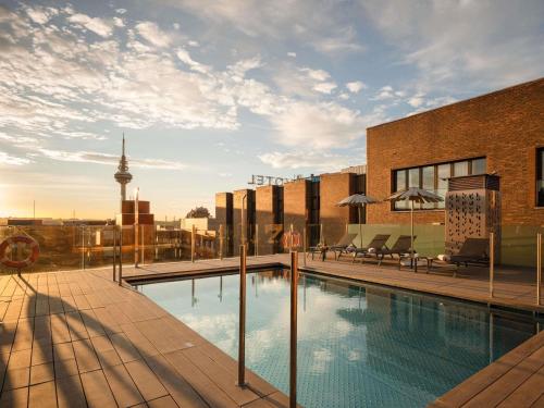 a swimming pool on the roof of a building at Novotel Madrid Center in Madrid