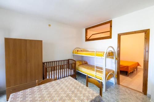 a bedroom with two bunk beds and a table at Agriturismo Millepini in Peschici