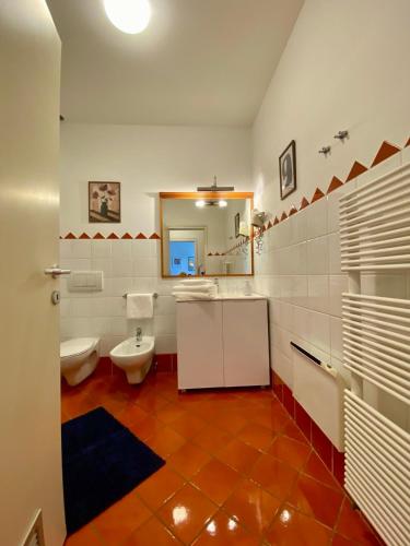 a bathroom with a toilet and a sink and a mirror at Lake Veronika in Bled