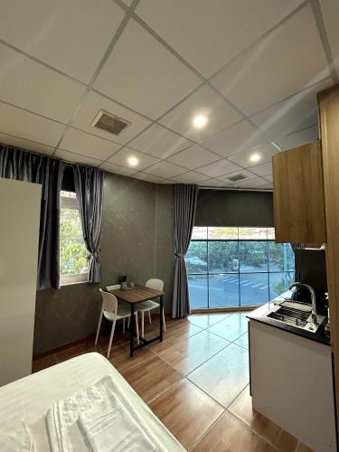 a kitchen and dining room with a table and a kitchen and a room at Linh's House in Danang