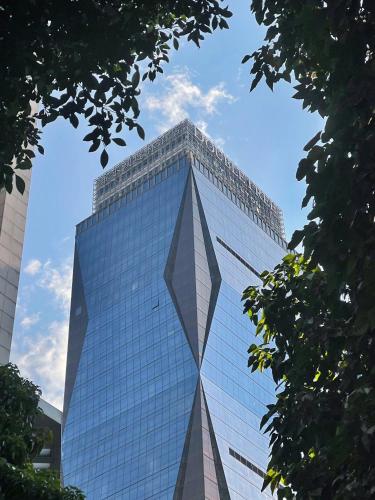 a tall glass office building with a blue sky at DoubleTree by Hilton Guangzhou in Guangzhou