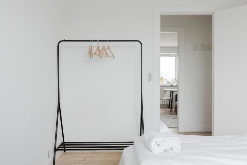 a mirror next to a bed in a room at Lovely cozy apartment in Søborg