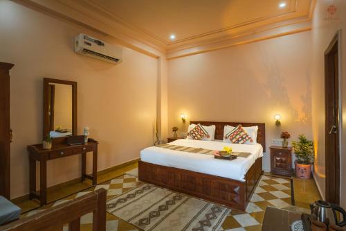 a bedroom with a large bed in a room at Eartham Stays, Pushkar in Pushkar