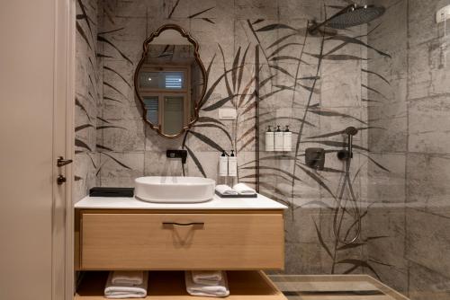a bathroom with a sink and a mirror at Heritage Hotel Zagreb Dubrovnik in Dubrovnik