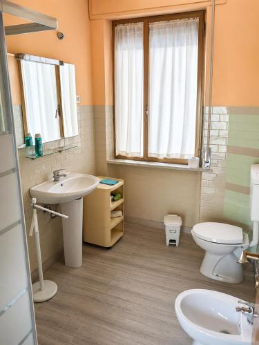 a bathroom with a sink and a toilet and a window at B&B I Pioppi Argentati in Giulianova