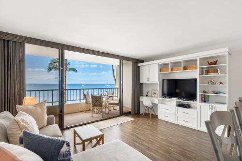 a living room with a view of the ocean at SUGAR BEACH RESORT, #421 in Kihei