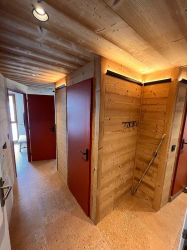 a room with wood paneling and two doors at Le Plainpalais - 4pers - Balcon vue Montagnes in Les Déserts