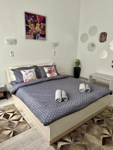 a bedroom with a bed with slippers on it at CITADEL ROOMS in Cluj-Napoca