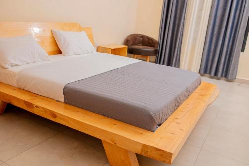 a bed sitting on a wooden platform in a room at RP Gorilla Guest & Coffee in Taba