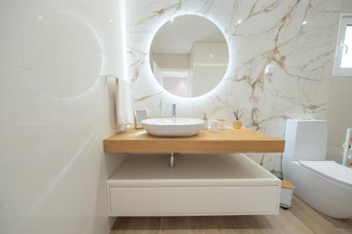 a bathroom with a sink and a mirror at Ponta do Pargo Village - By WeHostMadeira in Ponta do Pargo