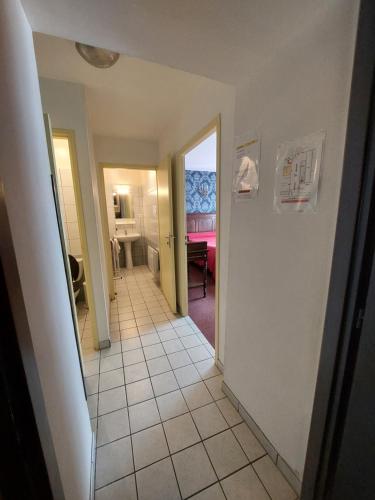 a hallway with a view of a room with a table at Le Commerce in Bulgnéville