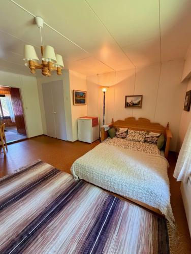 a bedroom with a bed and a large rug at Mattilan talo b&b in Impiö