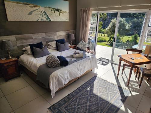 a bedroom with a bed and a sliding glass door at Mackenzies Accommodation in East London