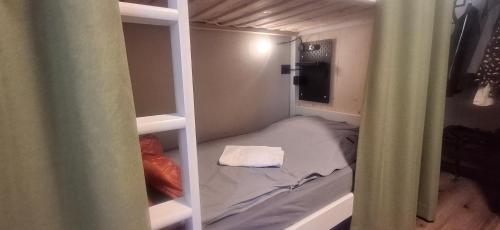 a small room with a bed in a closet at Inner Holiday Dolomites in Dimaro