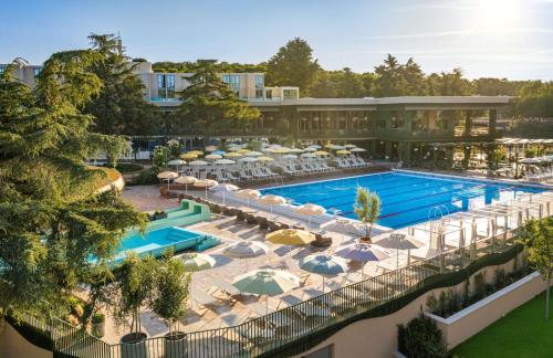 an aerial view of a resort pool with umbrellas at Valamar Diamant Hotel in Poreč